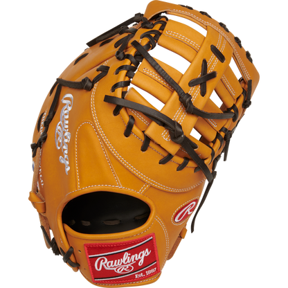 The Rawlings Heart of the Hide 13" First Base Mitt (RPROTDCTT) is tan with black laces, white stitching, and features the iconic red and white Rawlings logo patch on the wrist strap.