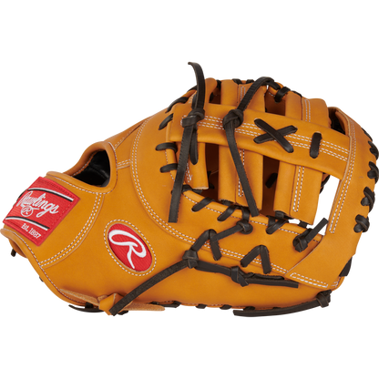 The Rawlings Heart of the Hide 13" First Base Mitt (RPROTDCTT) features tan leather, black laces, white stitching, and a red Rawlings logo patch on the wrist, displayed against a white background.
