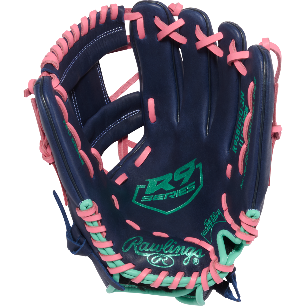 The Rawlings R9 11.5" Fastpitch Glove (R9SB115U-2N) features a navy blue design with pink laces, mint green accents, and the embroidered Rawlings logo plus signature palm details.