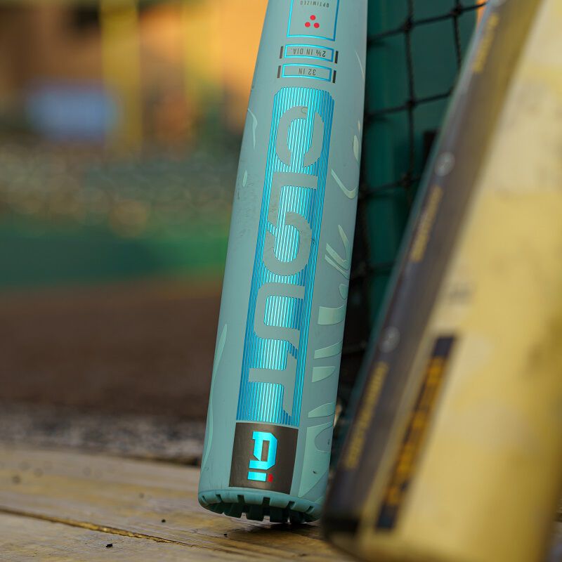 A 2025 Rawlings Clout AI (-3) BBCOR Baseball Bat: RBB5C3 (USED) by Rawlings leans against a net, ready for the next big game.