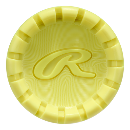 A yellow, circular, textured object with notched edges and a raised “R” at its center—a nod to the 2026 Rawlings Clout AI (-3) BBCOR Baseball Bat: RBB6C3 (DEMO) from Rawlings.
