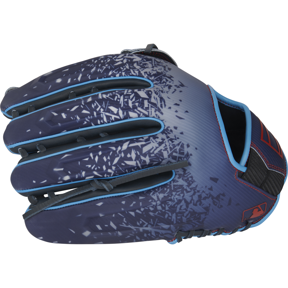 The Rawlings REV1X 12.75" Baseball Glove (RREV3039-6N) features a navy blue design with light blue trim, red accents, a shattered glass pattern on the back, MLB logo near the wrist, and a modern 12.75-inch size.