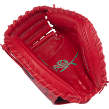 A vibrant red Rawlings REV1X 34″ Baseball Catcher’s Mitt (model REVCM43-23S) with noticeable stitching and lacing, highlighted by a green embroidered Rawlings logo on the inside palm area.