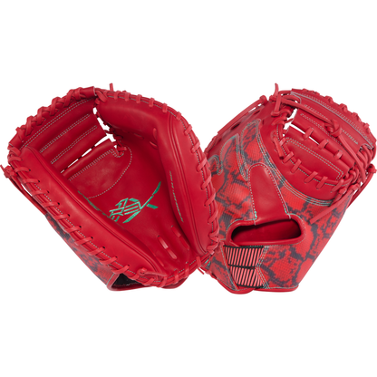 A vibrant red Rawlings REV1X 34″ Baseball Catcher’s Mitt (REVCM43-23S) by Rawlings, showcasing black and red snake-skin patterns, green stitching on the palm, and visible leather lacing along the edges.