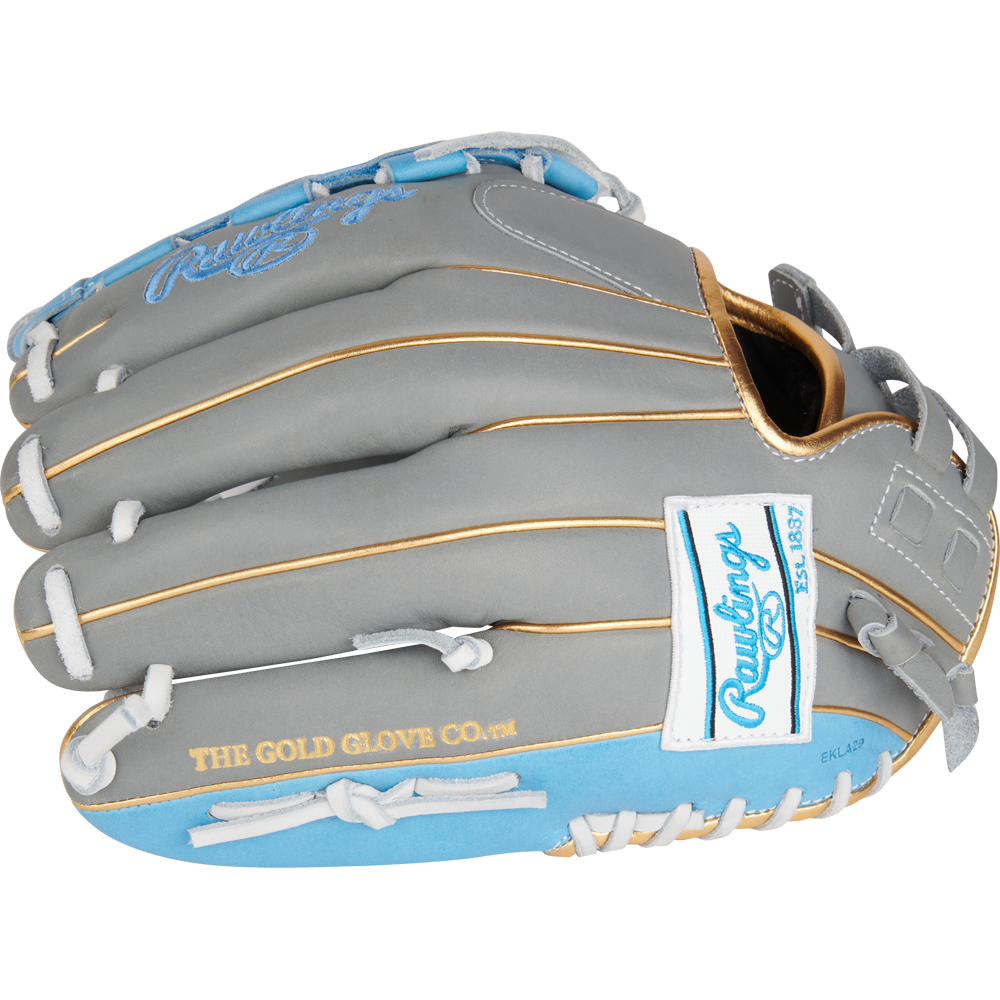 The Rawlings Liberty Advanced Color Sync 12" Fastpitch Softball Glove (RLA120-3GCB) features a gray and light blue design, tan stitching, white laces, gold "THE GOLD GLOVE CO." script, and a white Rawlings logo patch.
