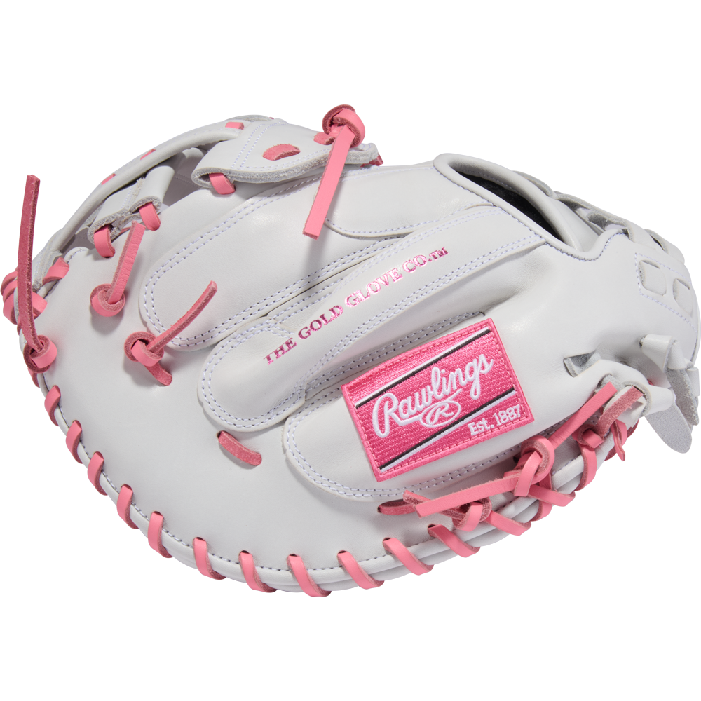The Rawlings Liberty Advanced 33" Fastpitch Catcher's Mitt (RLACM33FP-24WP) is a white glove with pink laces and accents, featuring the Rawlings logo and THE GOLD GLOVE CO. text in pink—ideal for fastpitch softball catchers.