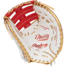 A close-up of the Rawlings Liberty Advanced Color Sync 13" Fastpitch First Base Mitt (RLADCTSBWSG) shows tan laces, red stitching, and the inner palm and webbing, featuring Rawlings branding and text throughout.