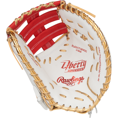 A close-up of the Rawlings Liberty Advanced Color Sync 13" Fastpitch First Base Mitt (RLADCTSBWSG) shows tan laces, red stitching, and the inner palm and webbing, featuring Rawlings branding and text throughout.