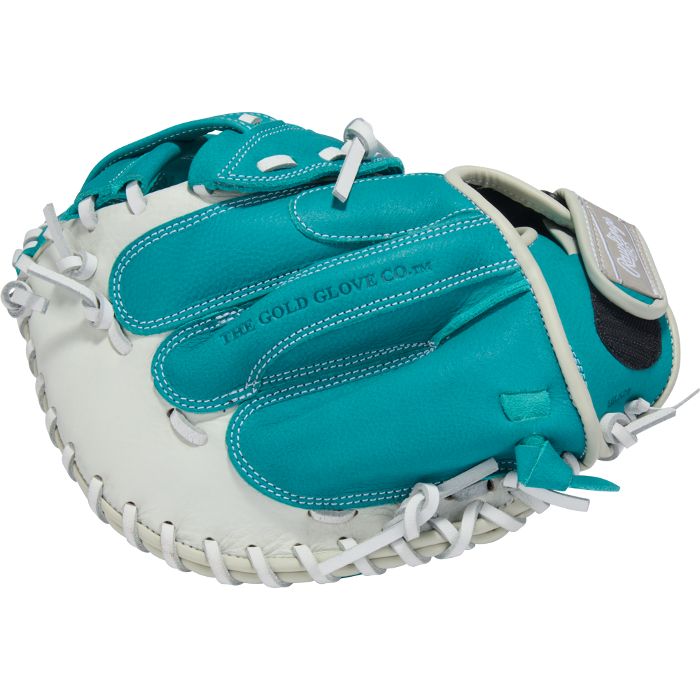 A teal and white Rawlings Shut Out 31.5" Fastpitch Catcher's Mitt (RSOCM315W) with white laces, featuring "THE GOLD GLOVE CO." printed on the palm.