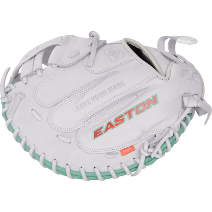 The Easton Jen Schro "The Rudi" 34" Fastpitch Catcher's Mitt (RUDI-2024) features a white design, teal lacing, red-orange EASTON branding, premium USA steerhide leather, and "LEAVE YOUR MARK" embossed above the logo.