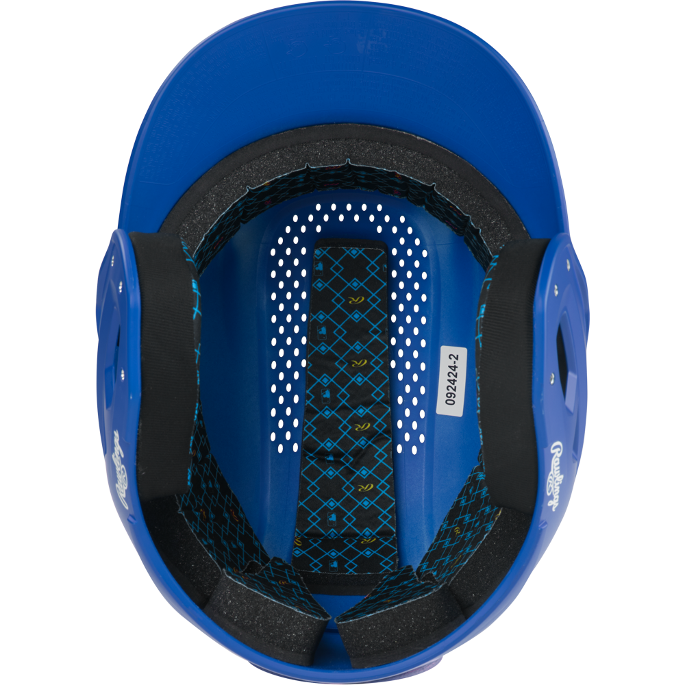 A top-down view of the inside of a blue Rawlings RX2 Matte Batting Helmet: RX2MAT, showing black foam padding, ventilation holes, and a patterned inner lining with a sticker labeled 089242.