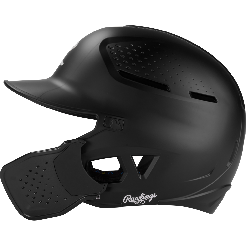 A black Rawlings RX2 Reverse Matte Batting Helmet: RX2REVMAT, featuring a protective face guard, ventilation holes, and reversible flap system, is shown in profile against a white background; NOCSAE-certified for safety.