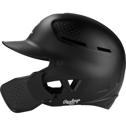 A black Rawlings RX2 Reverse Matte Batting Helmet: RX2REVMAT, featuring a protective face guard, ventilation holes, and reversible flap system, is shown in profile against a white background; NOCSAE-certified for safety.