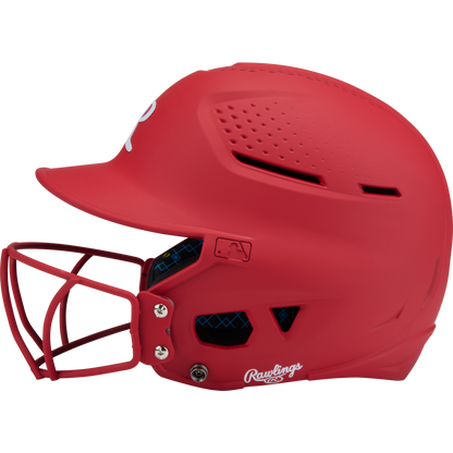 The Rawlings RX2 Matte Batting Helmet with Fastpitch Mask (RX2SBMAT) is shown in side profile, featuring ventilation holes and a white Rawlings logo near the ear, set against a plain background.