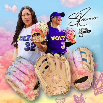 Two women in VOLT softball uniforms pose with Rawlings Heart of the Hide 12" Sierra Romero Game Model Fastpitch Glove (PROSR32C), decorated with sun and flower designs. Pastel clouds highlight Sierra Romero’s name, signature, and number 32.