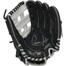 The Rawlings Sure Catch 11" Aaron Judge Youth Baseball Glove (SC110AJ) features a black and white design with white laces and Aaron Judge's signature on the palm.