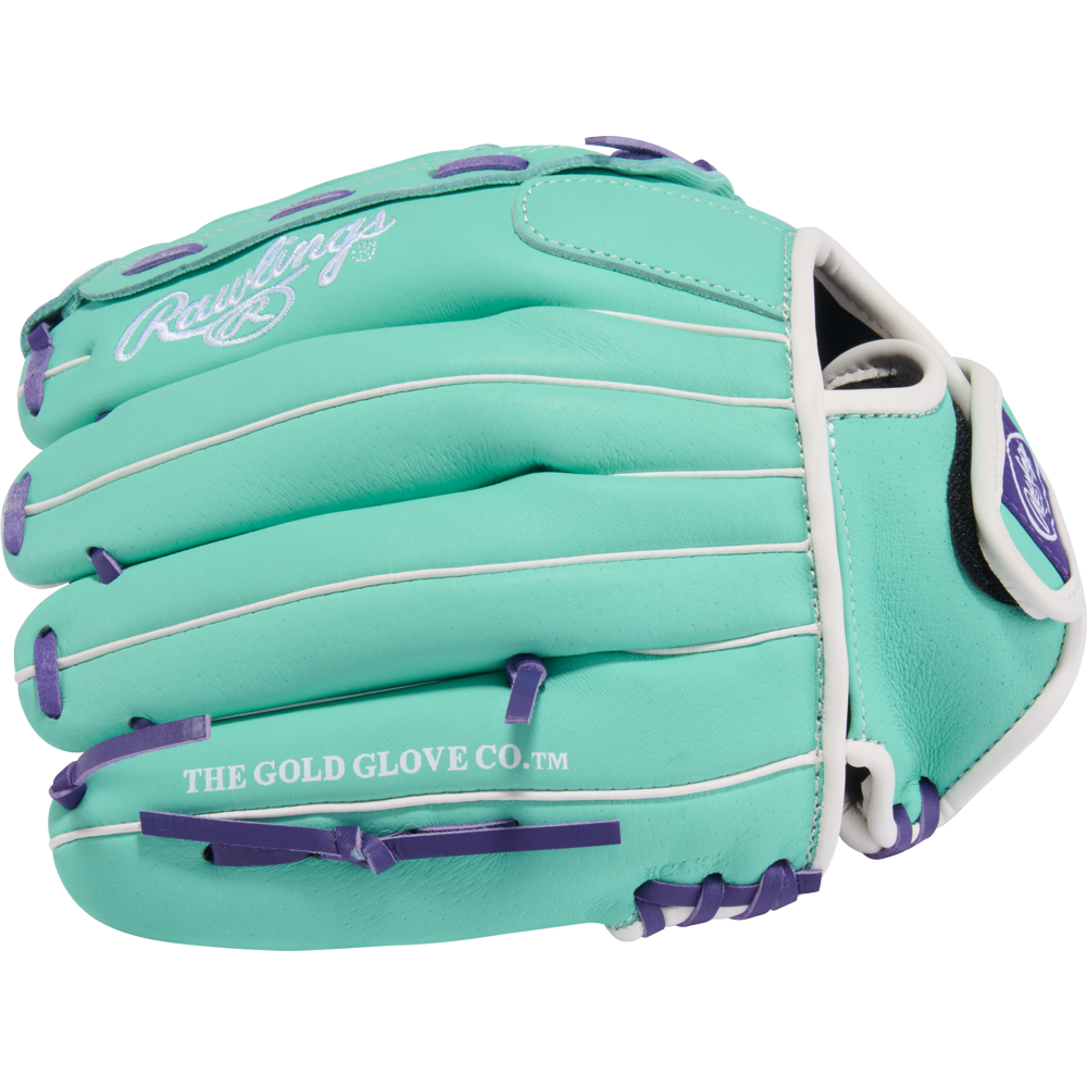 The Rawlings Sure Catch 11.5" Fastpitch Glove (SCSB115MW) is a teal youth glove with white lacing, purple accents, THE GOLD GLOVE CO.™ on the thumb, and the Rawlings logo—designed for easy fielding with Sure Catch technology.
