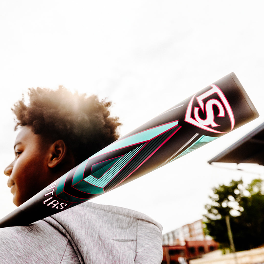 A person holding the 2025 Louisville Slugger Atlas (-3) BBCOR Baseball Bat (WBL2968010 DEMO), ready to swing.