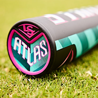Close-up of the 2025 Louisville Slugger Atlas (-3) BBCOR Baseball Bat (WBL2968010, DEMO), showing "ATLAS" and a pink LS logo on the end cap. The one-piece alloy bat features teal, pink, and black accents while resting on green grass.