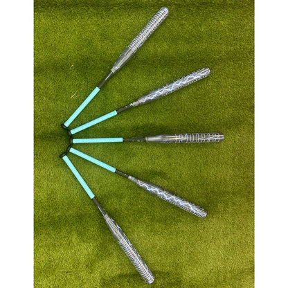 Six Pure Sports Storm Shadow 13″ Balanced USA Slowpitch Softball Bats (5147M91B) with turquoise handles are fanned out on green grass, handles meeting at the center and barrels radiating outward, mirroring the Storm Shadow X22 style.