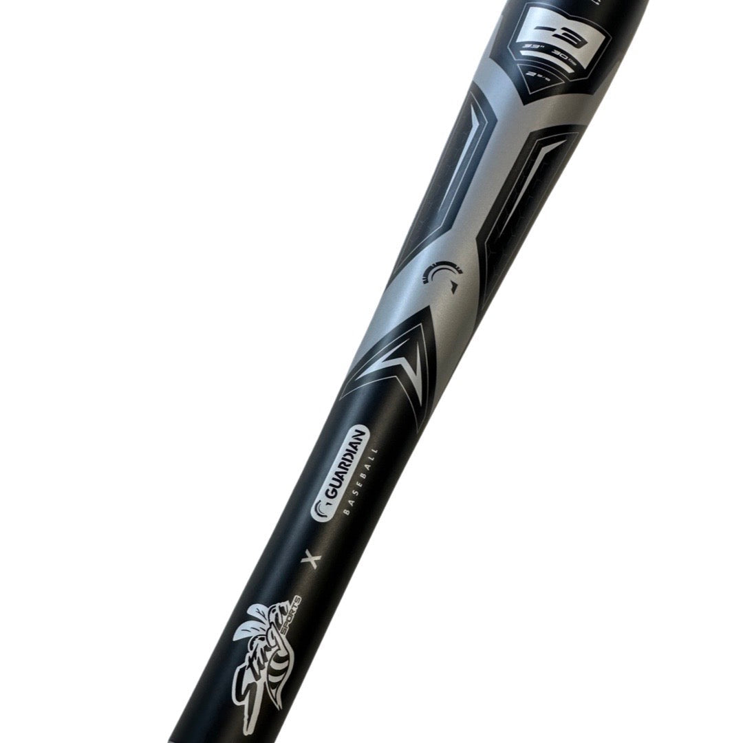 A close-up of the 2022 Stinger Guardian (-3) BBCOR Baseball Bat by Stinger Sports, showcasing bold graphics, balanced swing weight, black and silver design, and a -3 weight marking on the barrel.