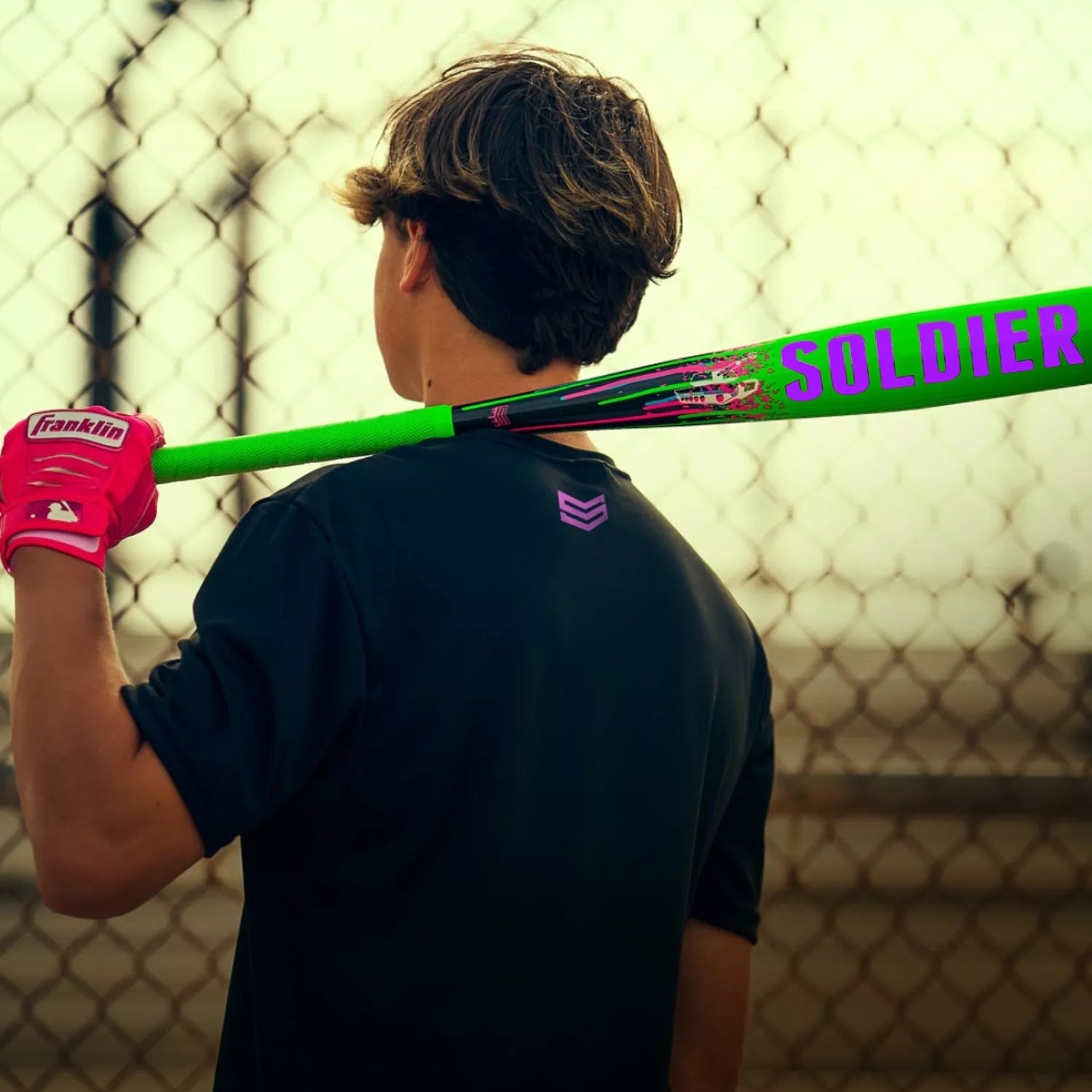 A man holding the 2026 Soldier Tank2 (-3) BBCOR Baseball Bat: BB-1-26 (DEMO) by Soldier Sports, designed with power alloy technology for a light swing weight.