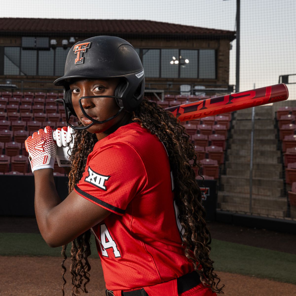 A woman holding a 2026 Easton Ghost Advanced (-11) Fastpitch Softball Bat (DEMO).