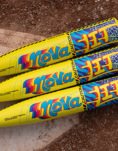 Three vibrant Victus Nova Lit (-10) 2 3/4" USSSA Baseball Bats (VSBNL10) feature bold blue, red, and orange designs with "CAUTION" printed near the barrel tips, displayed side by side on a textured brown surface.