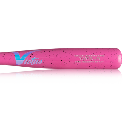 A close-up of the Victus TATIS JR Youth Pro Reserve Birch Wood Bat (VYRWBTATISJR) in pink with black speckles and "Victus" in white and blue on the barrel, highlighting its balanced feel.