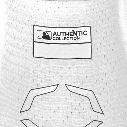 Close-up of a white EvoShield PRO-SRZ 2.0 Batter's Elbow Guard (WB572600) jersey with “AUTHENTIC COLLECTION” MLB logo patch, a blank label, and a gray geometric design inspired by the guard’s advanced fabric technology.
