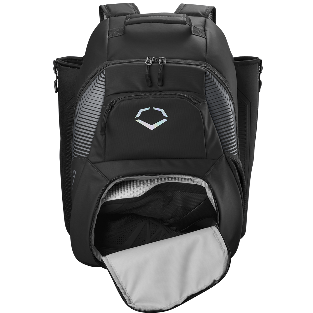 The EvoShield Tone Set Backpack: WB57304 is a black, water-resistant bag with front zipper pocket, side pockets, padded shoulder straps, ventilated lower compartment (flap open), and a geometric logo—perfect for baseball gear.