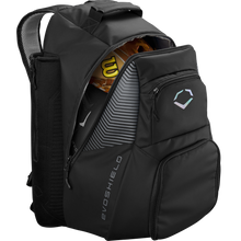 The EvoShield Tone Set Backpack (WB57304) is a black, water-resistant baseball gear bag with multiple compartments, bat sleeves, and a subtle EvoShield logo on the front pocket. The partially unzipped bag reveals a glove and bat inside.