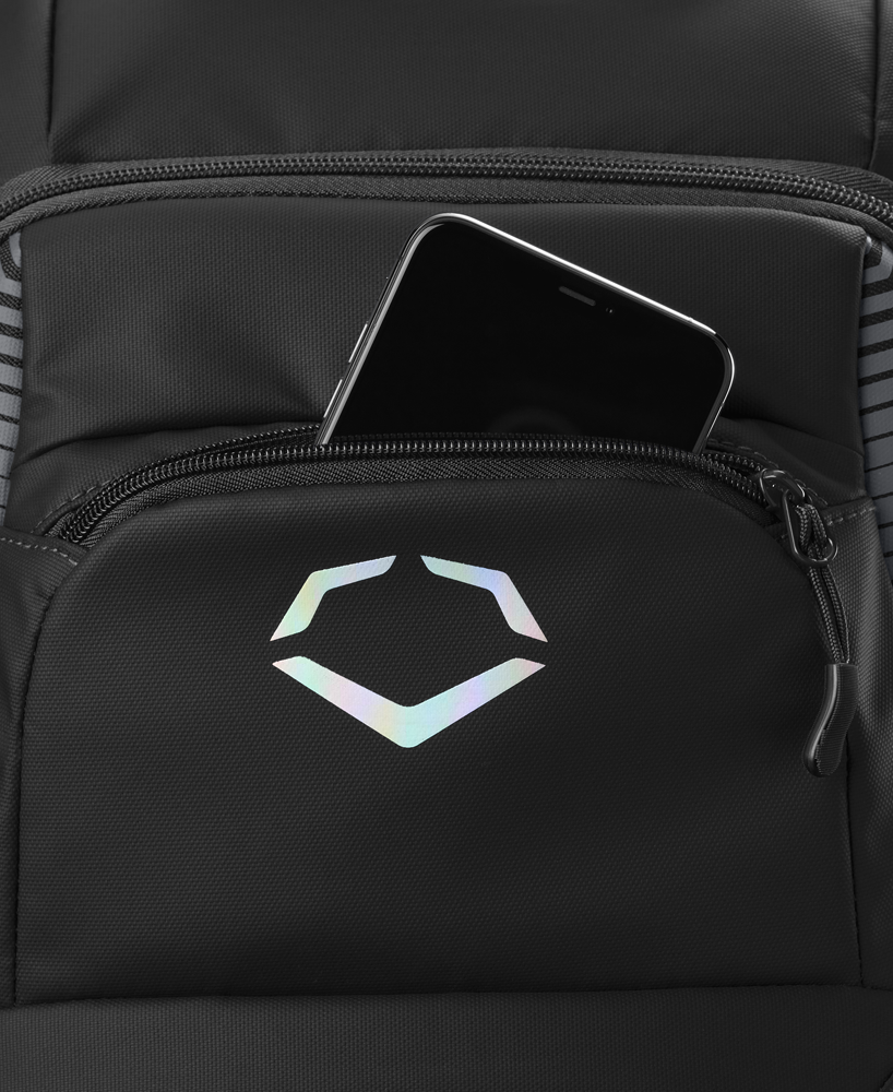 The EvoShield Tone Set Backpack (WB57304) by EvoShield is a black, water resistant backpack featuring a holographic geometric logo and bat sleeves for versatile use—shown partially unzipped with a black smartphone inside.