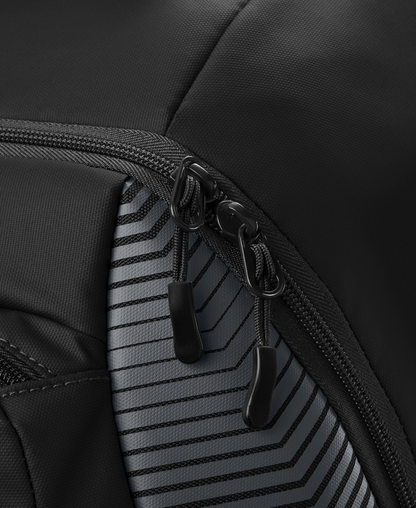 Close-up of two black zipper pulls on the EvoShield Tone Set Backpack (WB57304) by EvoShield, featuring water-resistant, durable fabric with a gray and black geometric striped pattern—perfect as a baseball gear bag.