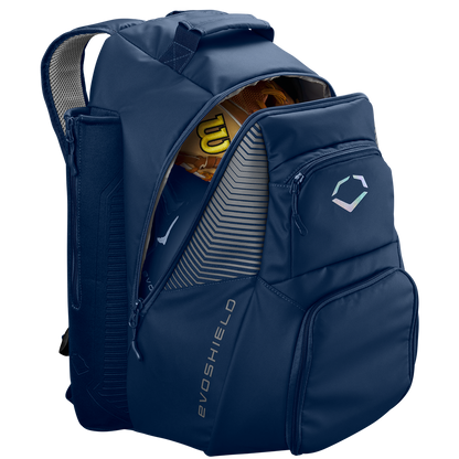 The EvoShield Tone Set Backpack: WB57304 is a navy blue, water-resistant backpack with bat sleeves, multiple zippered pockets, padded shoulder straps, and a partially open main compartment showing a yellow Wilson baseball glove.