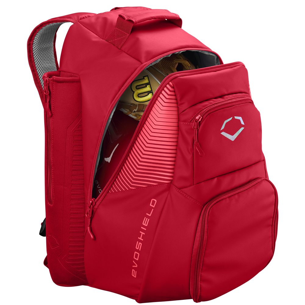A red EvoShield Tone Set Backpack: WB57304 with water resistance, multiple zippered compartments, dedicated bat sleeves, and a white geometric EvoShield logo on the front pocket. Shown partially unzipped to reveal a yellow glove and bat inside.