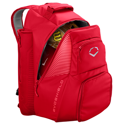 A red EvoShield Tone Set Backpack: WB57304 with water resistance, multiple zippered compartments, dedicated bat sleeves, and a white geometric EvoShield logo on the front pocket. Shown partially unzipped to reveal a yellow glove and bat inside.