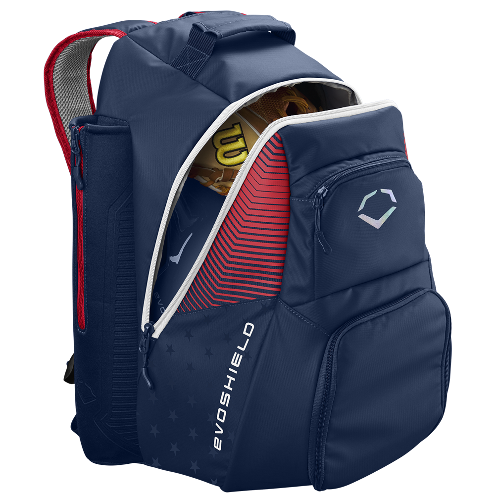 The EvoShield Tone Set Backpack: WB57304 by EvoShield, in USA colors, features multiple compartments, bat sleeves, a water-resistant design, and displays the EvoShield logo on the front pocket. A baseball glove is partially visible inside.