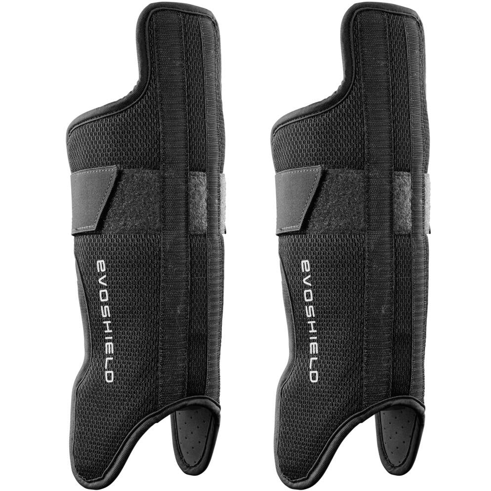 A pair of black EvoShield wrist guards with textured surfaces, adjustable straps, and white EvoShield logos lay flat next to the EvoShield G2S Baseball Catcher's Gear Kit (WB5744401), perfect for sports protection.