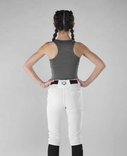 A girl with braids wearing white pants and an EvoShield Women's Racerback Chest Guard Sleeveless Shirt.