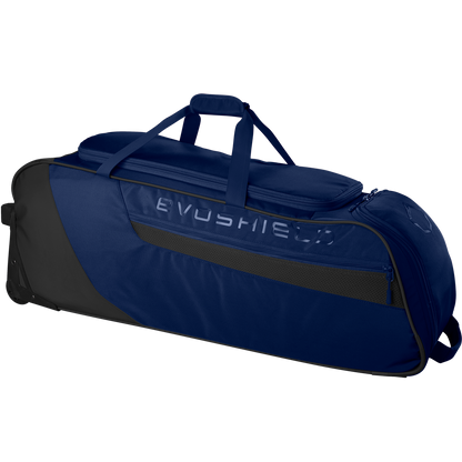 The EvoShield Takeover Wheeled Bag (WB57572) is a large, navy blue and black bag with EVOSHIELD branding, bat sleeves, a top handle, side pocket, and wheels for easy baseball gear transport.