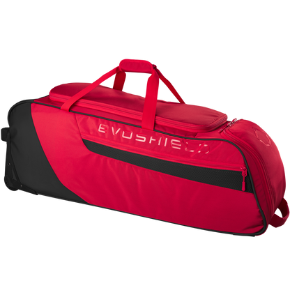 The EvoShield Takeover Wheeled Bag (WB57572) is a spacious red and black gear bag featuring a top handle, side mesh pocket, zippered compartments, and bat sleeves for easy baseball equipment transport.