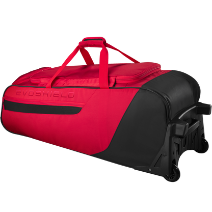 The EvoShield Takeover Wheeled Bag (WB57572) is a large red and black gear bag with sturdy wheels, a top handle, and bat sleeves—ideal for baseball gear. EvoShield branding is embossed on the side.