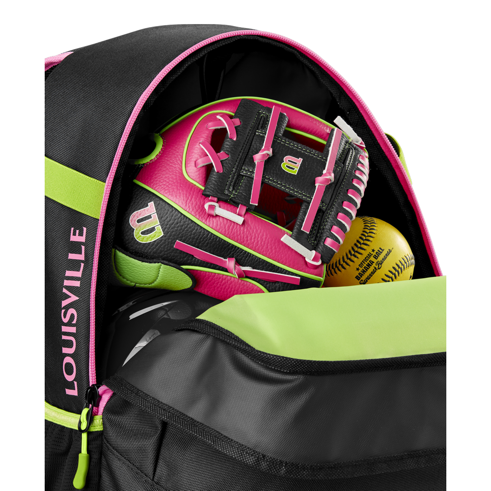 A close-up of an open Louisville Slugger Party Animals Powerized Stick Pack Backpack reveals a neon pink and black Wilson softball glove and two yellow softballs inside its main compartment.