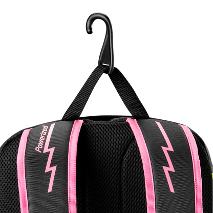 A black Louisville Slugger Party Animals Powerized Stick Pack Backpack with pink lightning bolt designs and pink-trimmed straps hangs from a black hook by its fabric loop, featuring the Louisville Slugger brand on one strap.
