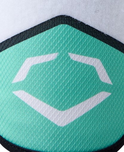 Close-up of a textured turquoise surface featuring EvoShield’s white geometric logo, outlined in black, on a white background. Inspired by the EvoShield SRZ-2 Youth Batter's Elbow Guard: WB57645, renowned for its Gel-to-Shell technology.
