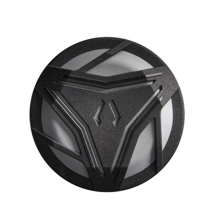 A round black and gray object with angular, textured lines and a symmetrical central pattern, reminiscent of the 2024 DeMarini ZOA (-8) 2 3/4" USSSA Baseball Bat: WBD2467010 by DeMarini.