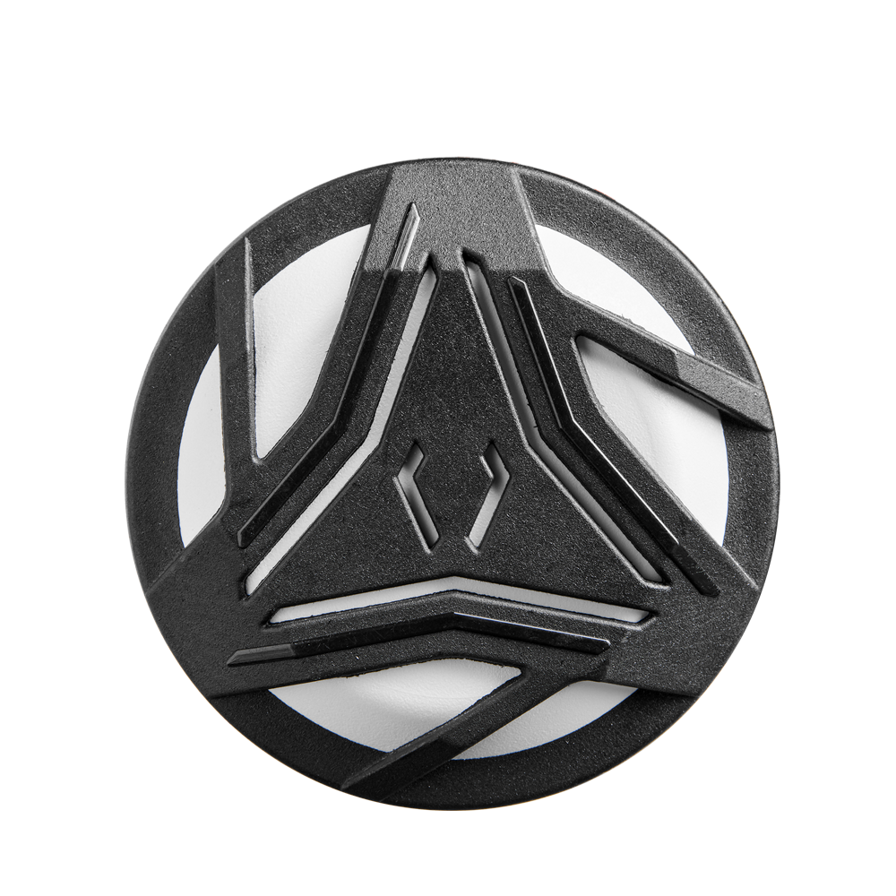 A round, black object featuring geometric cutouts reminiscent of the 2025 DeMarini Whisper (-9) Fastpitch Softball Bat (WBD2545010), its design echoing the bat's futuristic Amplified Gapped Wall Barrel pattern for a strikingly modern look.