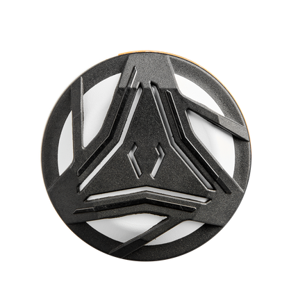 A round object with a white base and black angular, intersecting lines resembles the Gapped Wall Barrel tech of the 2025 DeMarini Prism+ (-11) Fastpitch Softball Bat: WBD2547010 (USED) by DeMarini, viewed from above on a plain background.