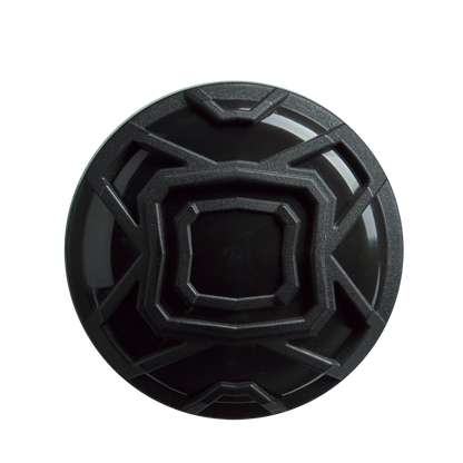 A black, circular object with a geometric raised angular pattern—resembling the end cap of the DeMarini The Goods (-3) BBCOR Baseball Bat (2026, WBD2588010)—is viewed from above against a plain white background.